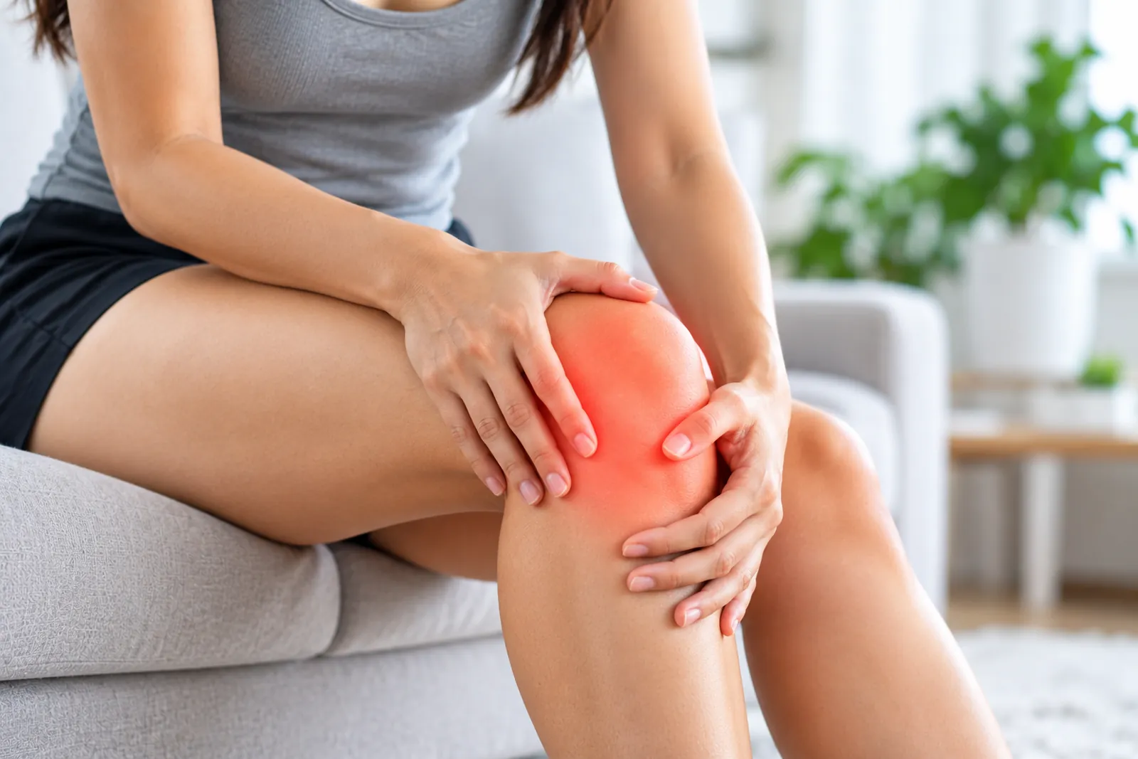 Woman holding her painful knee