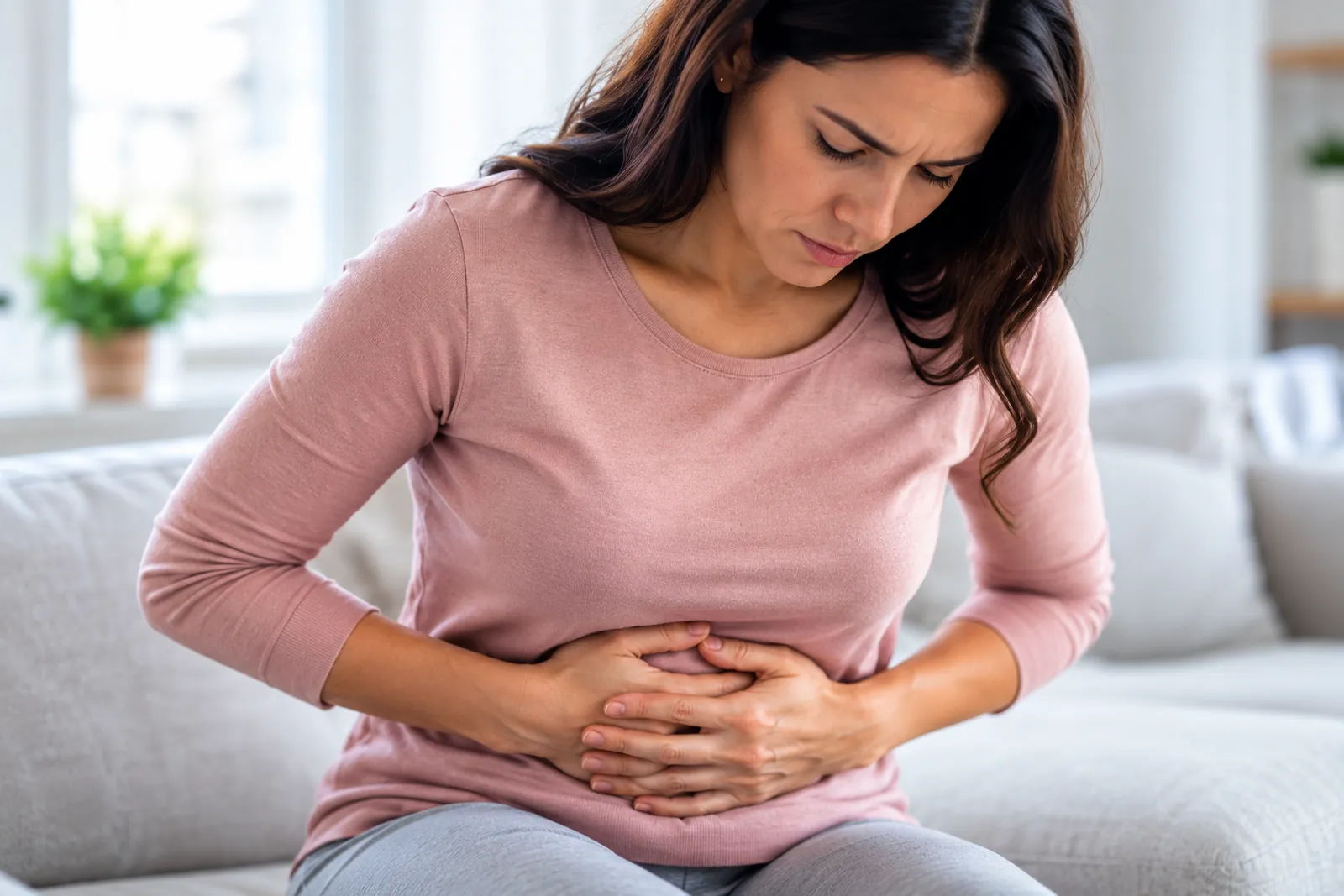 Woman holding her lower abdomen