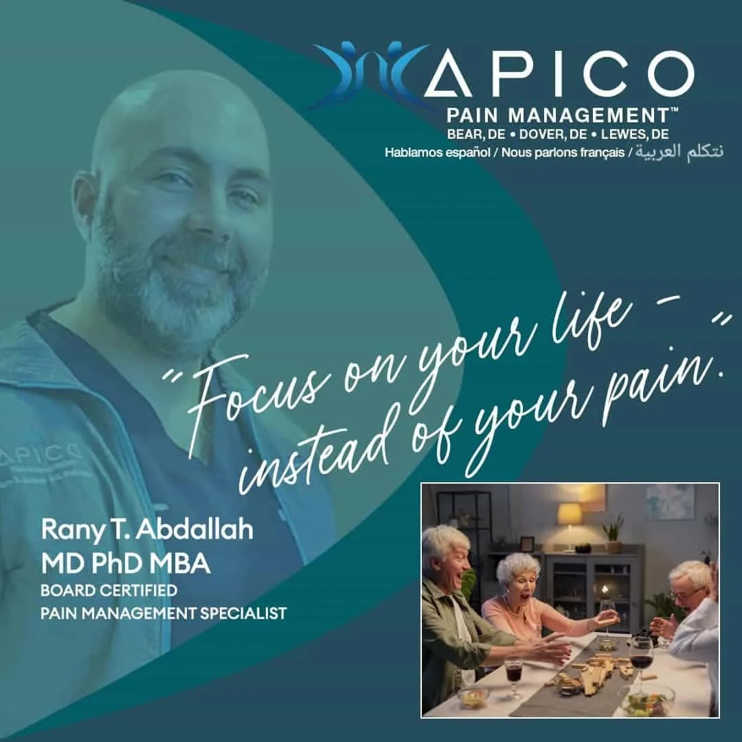 ???????????????????? ???????????? ???????????? ????????????????????????ℎ???????????? ????????????’???????? ???????????????? ???????????? ???????? says A smiling woman enjoying a board game and wine with friends, representing relief from chronic pain. Text reads: “Focus on your life instead of your pain.” The image promotes APICO Pain Management, a trusted provider of pain relief in Delaware, with office locations in Lewes, Bear, and Dover.