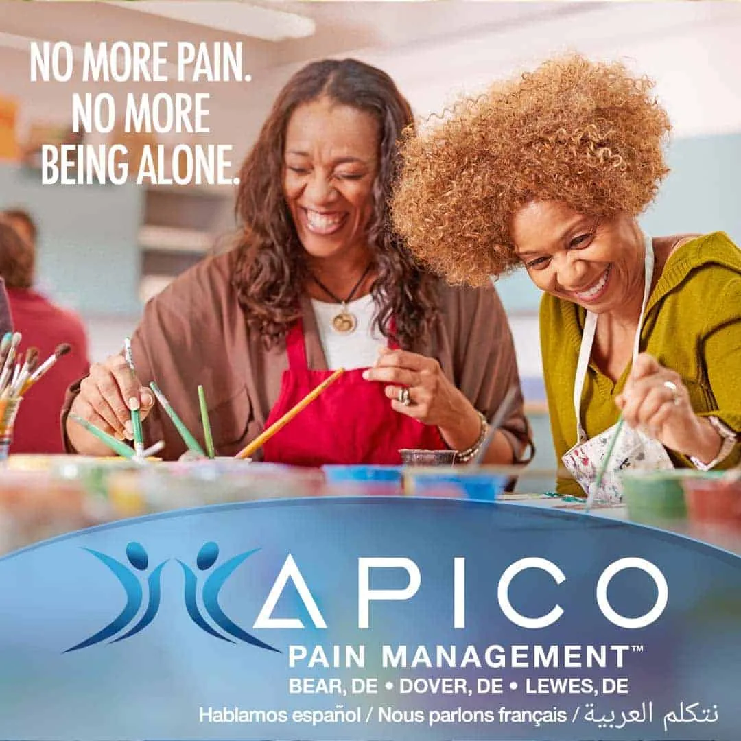 Image of two female friends laughing while working toether, because they no longer suffer from chronic pain.
