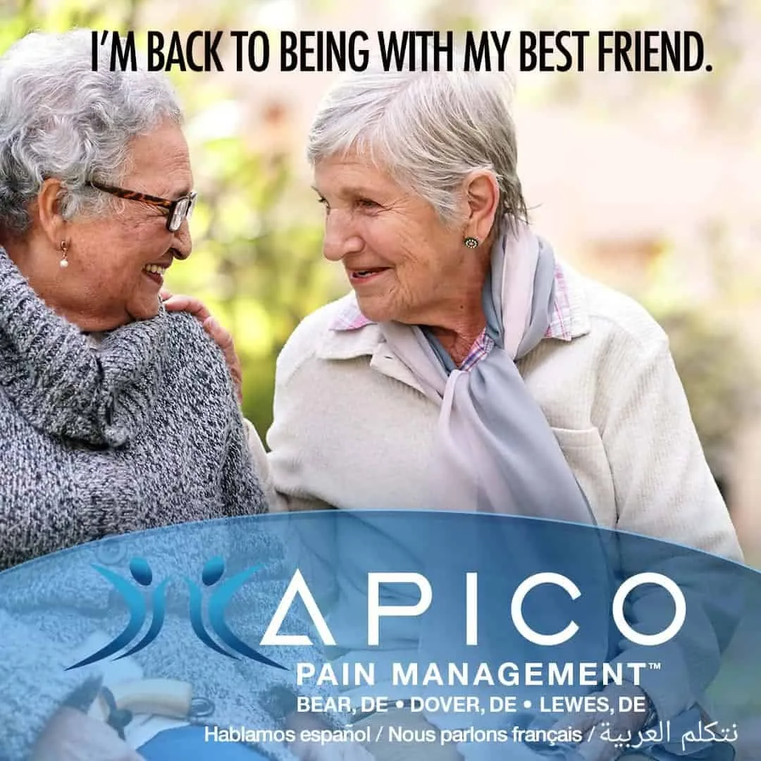 Image of two friends, back together smiling, because they are no longer suffering from chronic pain.