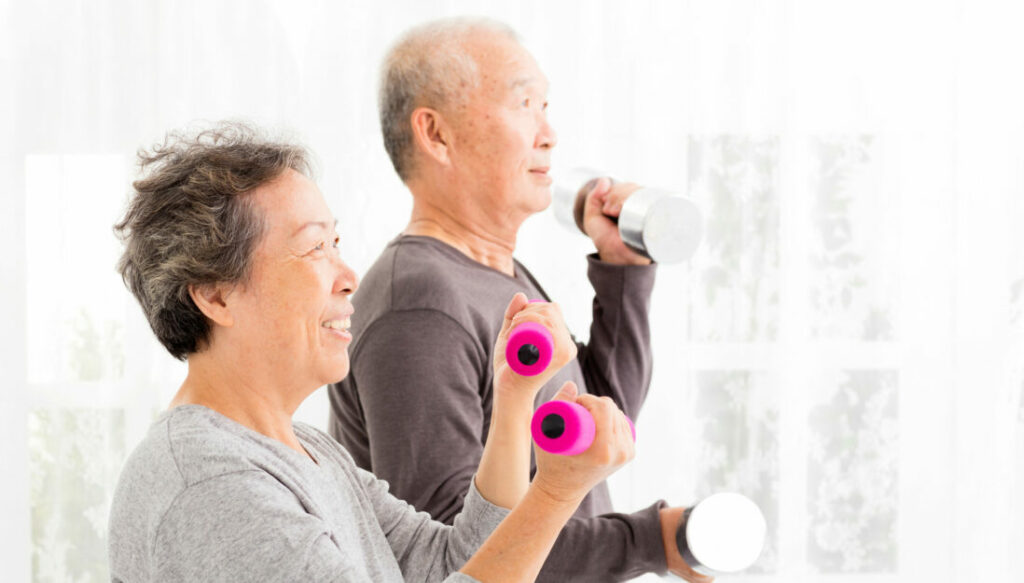 Couple exercising with dumbells.
