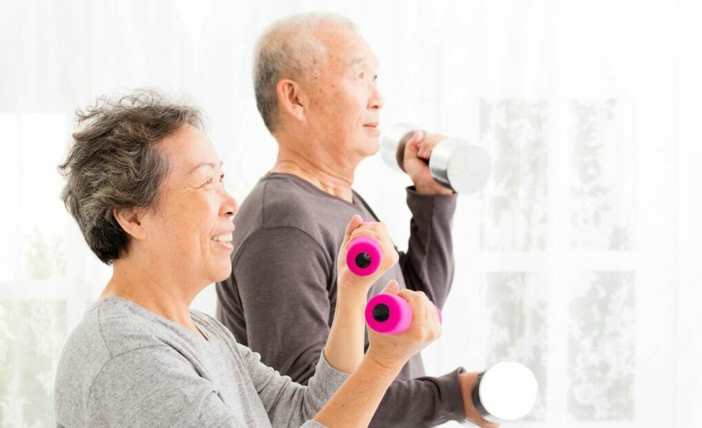 Couple exercising with dumbells.