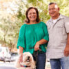 Smiling man and woman with their dog