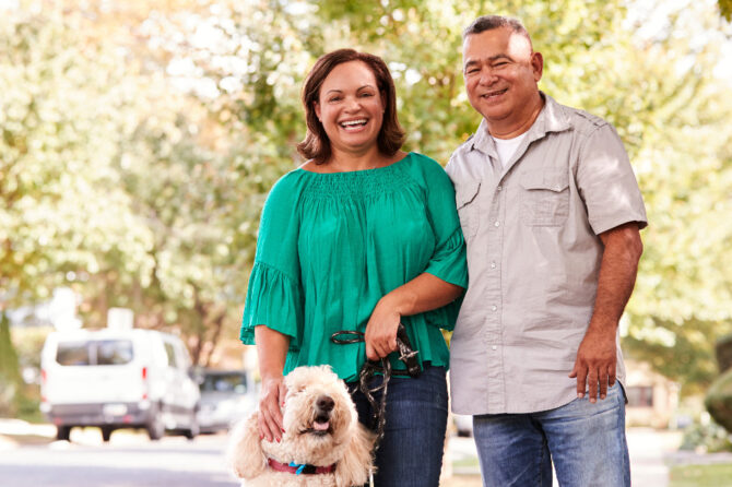 Smiling man and woman with their dog