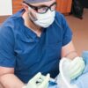 Photo of Dr. Abdallah performing a procedure on a patient.