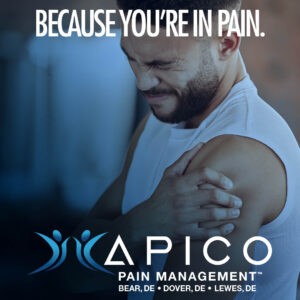 Photo of a man in pain holding his left shoulder